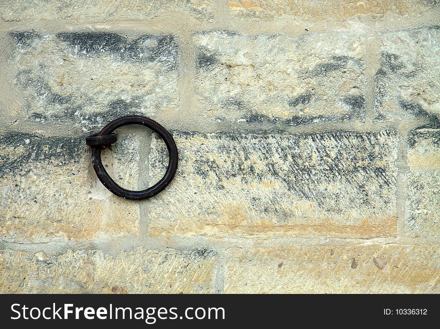 Iron ring set in a brick wall; with copy space