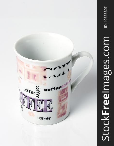 Empty white coffee cup with the word coffee printed all over in different letters and typos