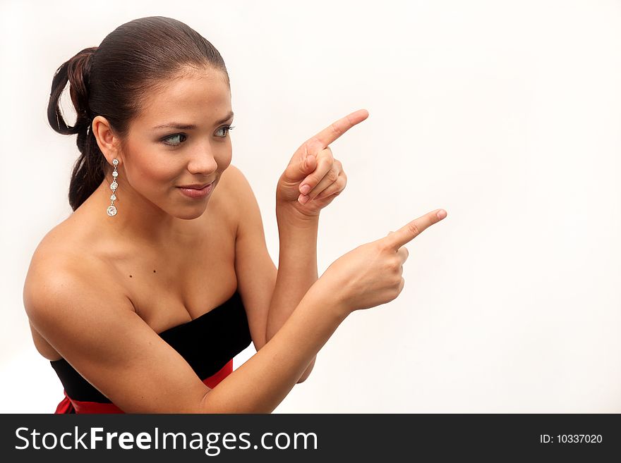 Young charming girl shows it wall for advertising