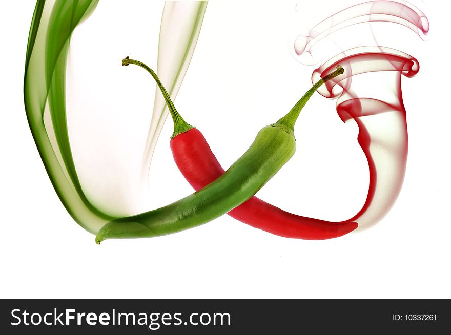 Red and green hot chili pepper with color smoke on white