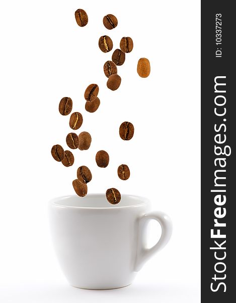 White cup with coffe beans isolated
