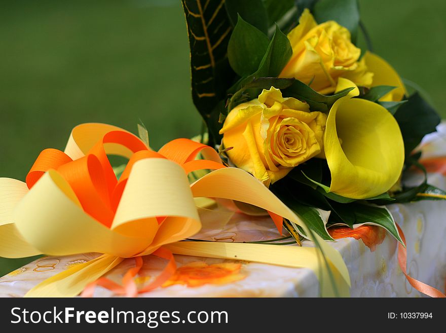 Decorated present with yellow rose bouquet