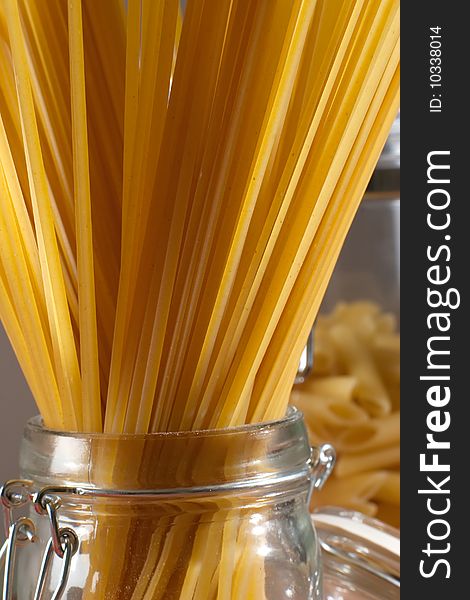 Close up shot of raw spaghetti in a glass container ready for cooking