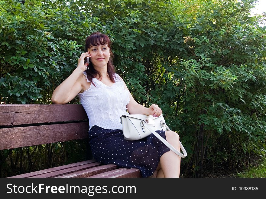 Middleaged woman talks on the mobile phone. Middleaged woman talks on the mobile phone