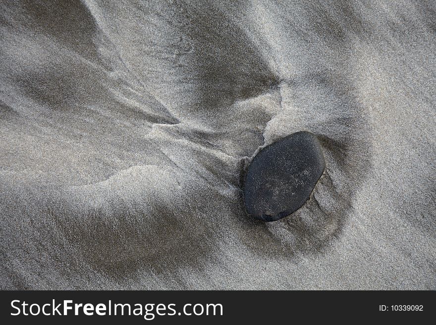 Stone on sand beach and surf track. Stone on sand beach and surf track