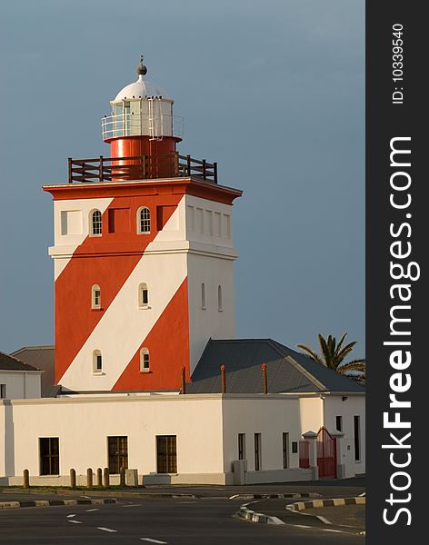 Red and white Lighthouse at sunset
