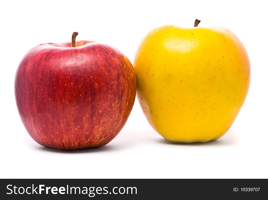 Red and yellow fresh apples on studio white