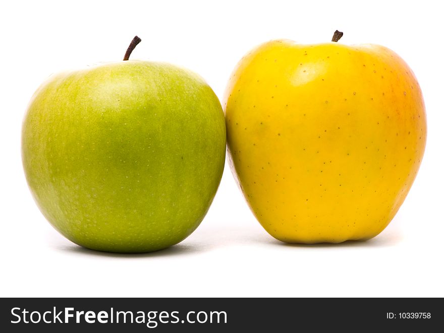 Green and yellow fresh apples on studio white