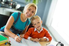 Cute Boy And His Mom Sit At The Desk In The Office And Draw Stock Photography Cute Boy And His Mom Sit At The Desk In The Office And Draw Stock Photography