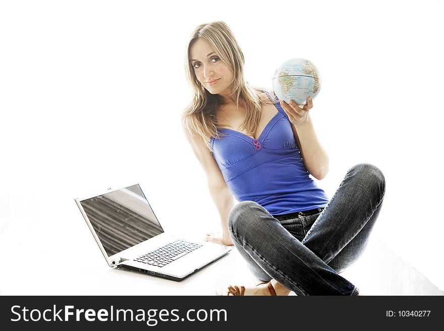 Woman holding a small globe in her hand.