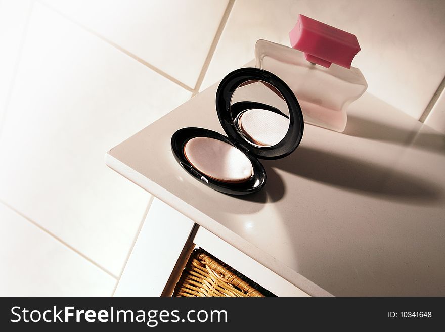 Black makeup box on a white table in the bathroom