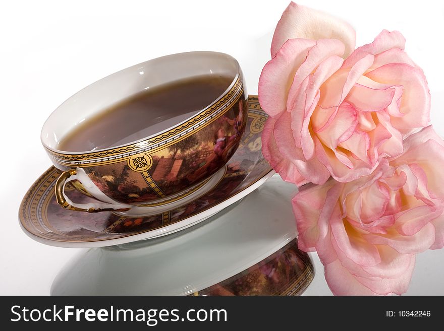 Flavored tea in a white porcelain bowl and a flower