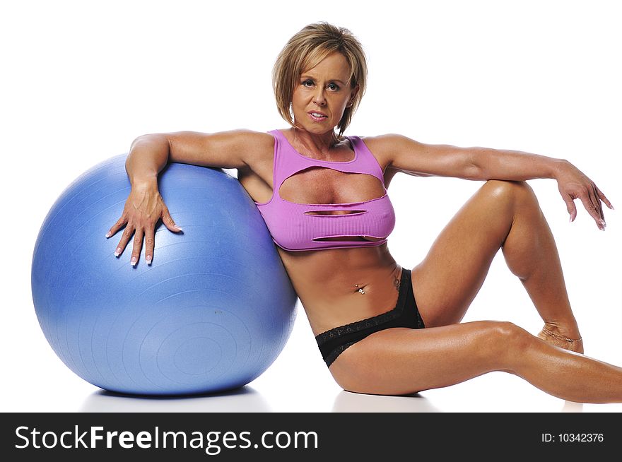 Woman working out using a ball and isolated on white background
