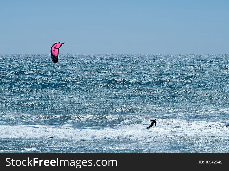 Kiteboarding on a very choppy sea in Southern California. Kiteboarding on a very choppy sea in Southern California