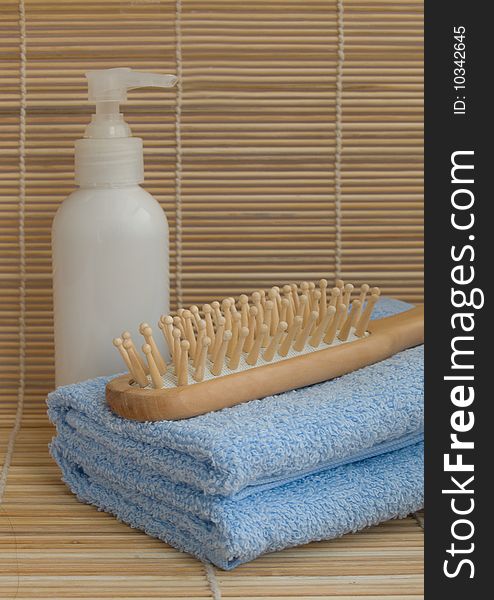 Towels,  wood hairbrush,  and liquid soap. Towels,  wood hairbrush,  and liquid soap
