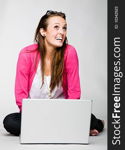 Attractive young woman celebrating with laptop