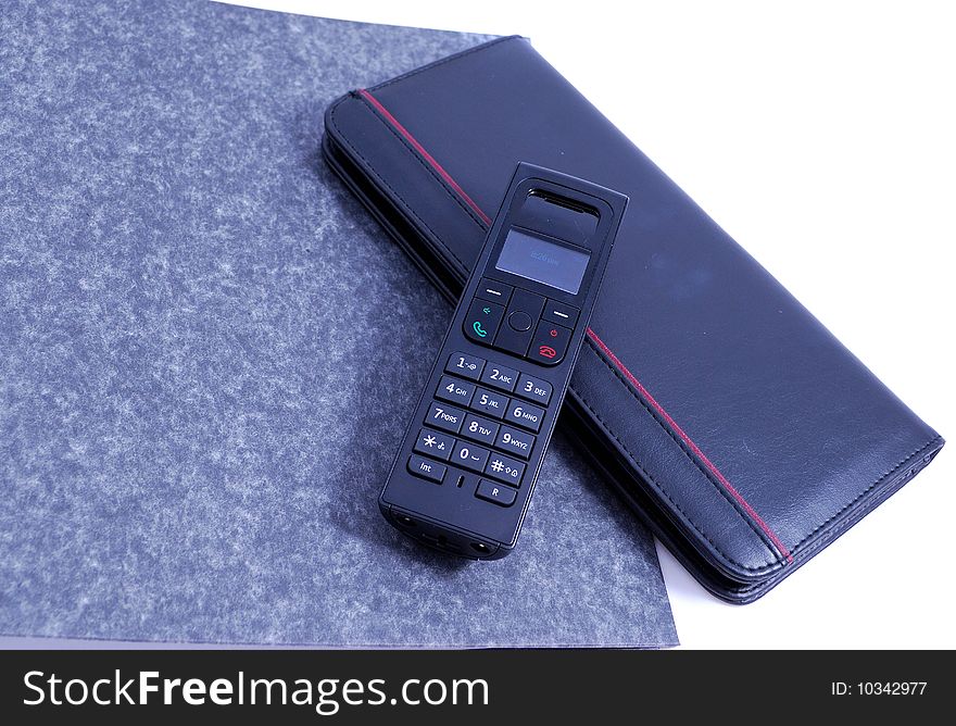 Wireless phone with notebook on white background