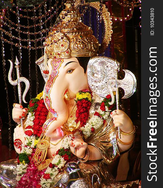 A beautiful idol of lord Ganesha with dazzling gold and silver jewelery all over him. A beautiful idol of lord Ganesha with dazzling gold and silver jewelery all over him