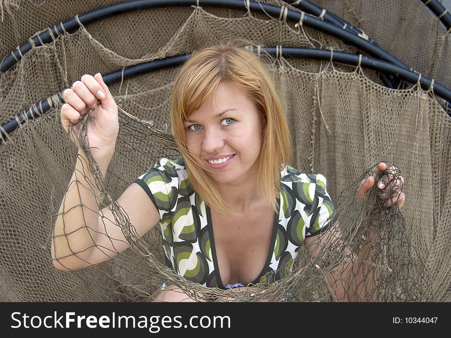 Beautiful young woman in the fishing net. Beautiful young woman in the fishing net