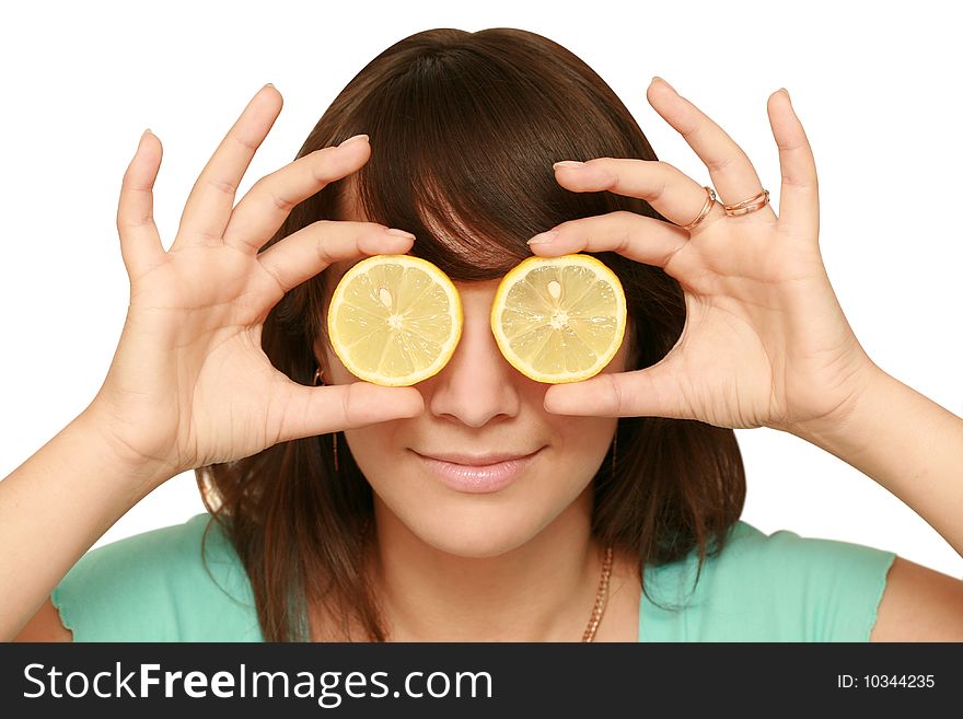 Woman covers eyes of two slices of lemon. Woman covers eyes of two slices of lemon