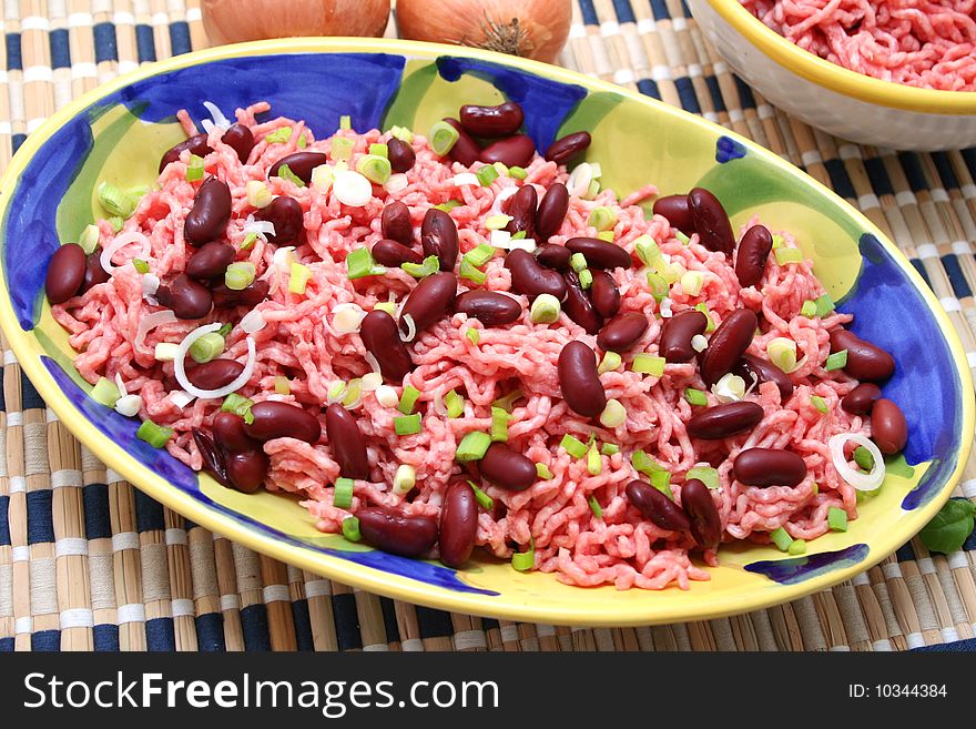 Some fresh meat with onions and kidney-beans. Some fresh meat with onions and kidney-beans