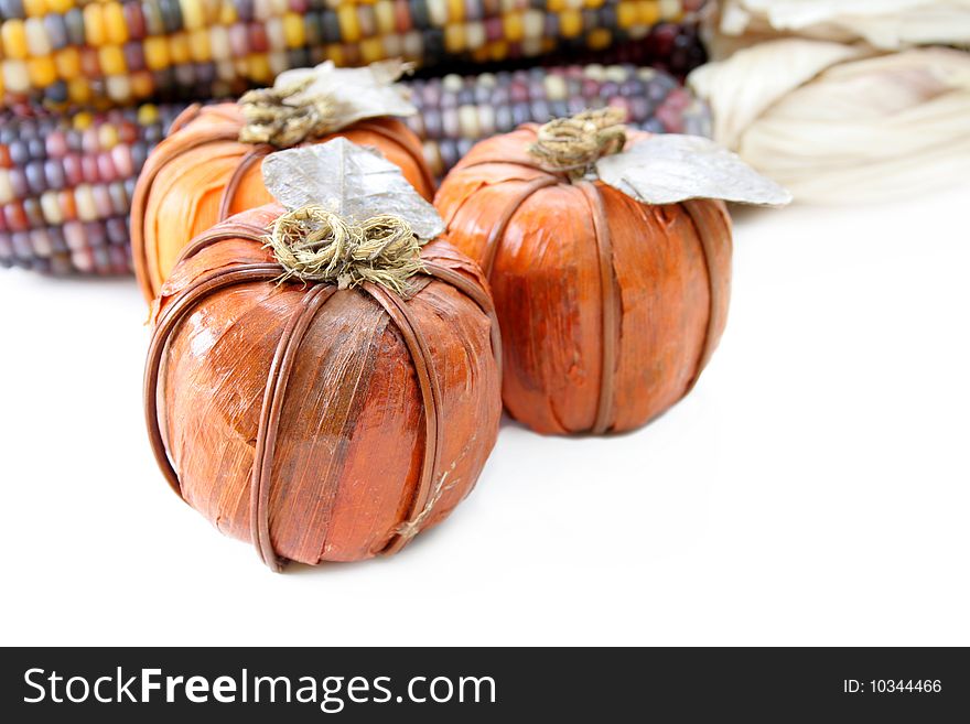 Pumpkins and indian corn done on a white background for the holidays. Used a selective focus with a shallow depth of field. Pumpkins and indian corn done on a white background for the holidays. Used a selective focus with a shallow depth of field.