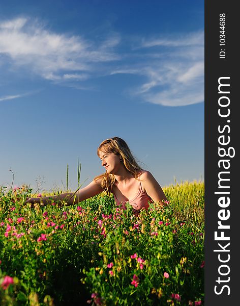 The girl sit field and collects poppy. The girl sit field and collects poppy