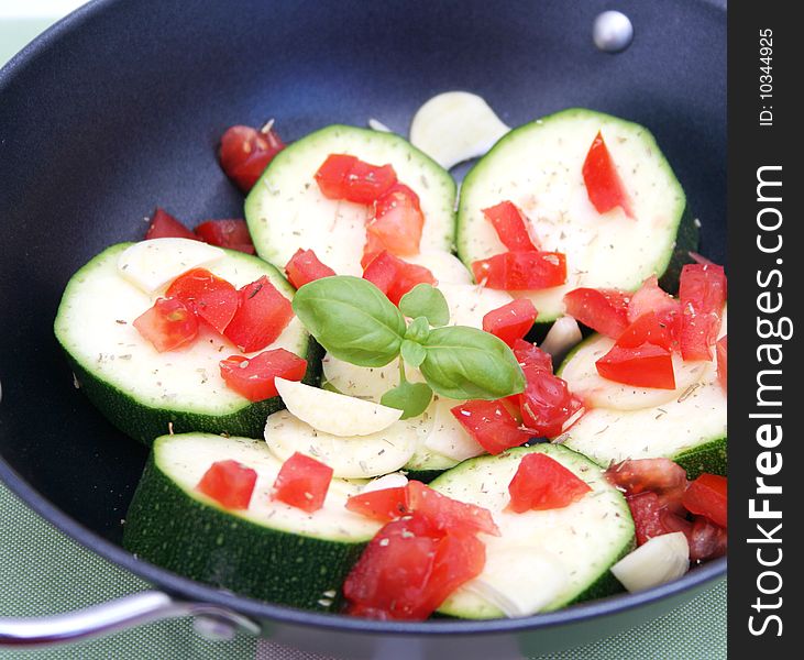 Some fresh zucchini and tomatoes with garlic. Some fresh zucchini and tomatoes with garlic