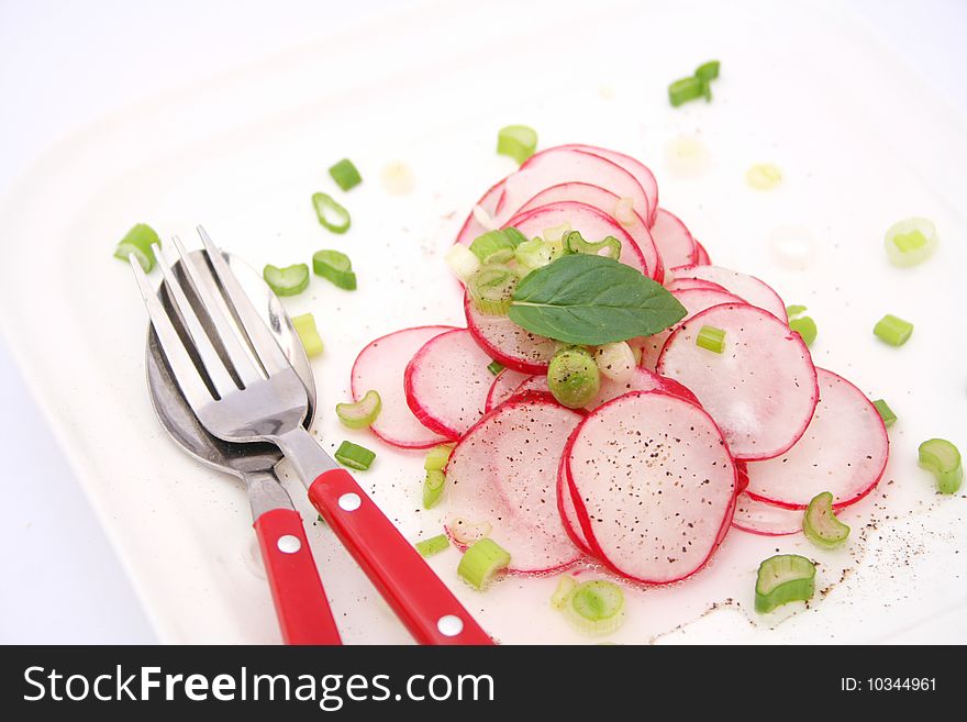 A fresh salad of red reddish on a plate