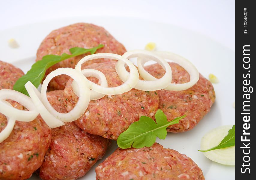 Some fresh, raw meat balls with onions. Some fresh, raw meat balls with onions