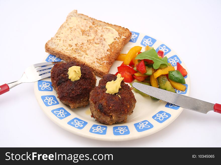 A snack of meatballs with salad of peppers