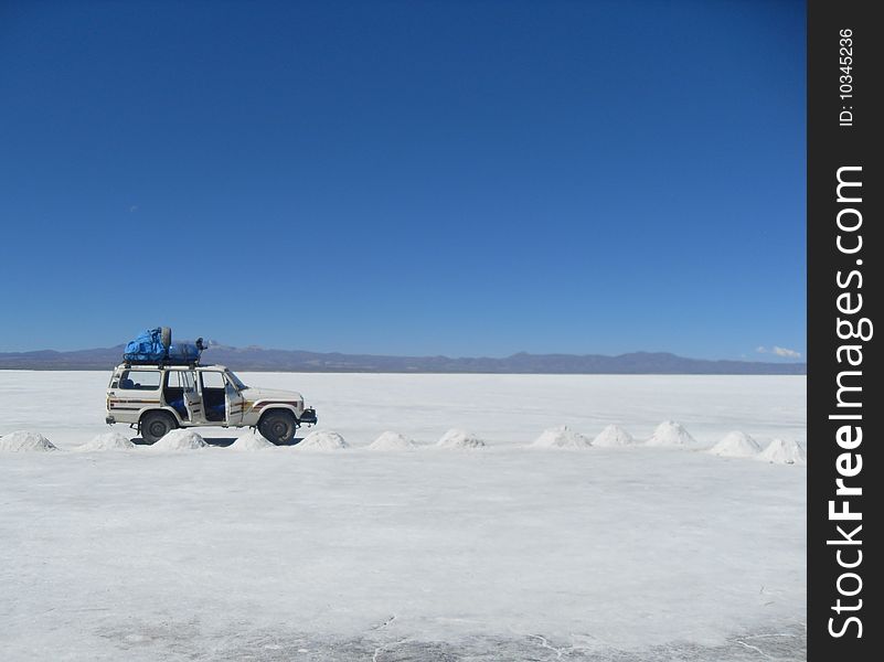 The parked 4 x 4 on the salt plains of Bolivia. The parked 4 x 4 on the salt plains of Bolivia.