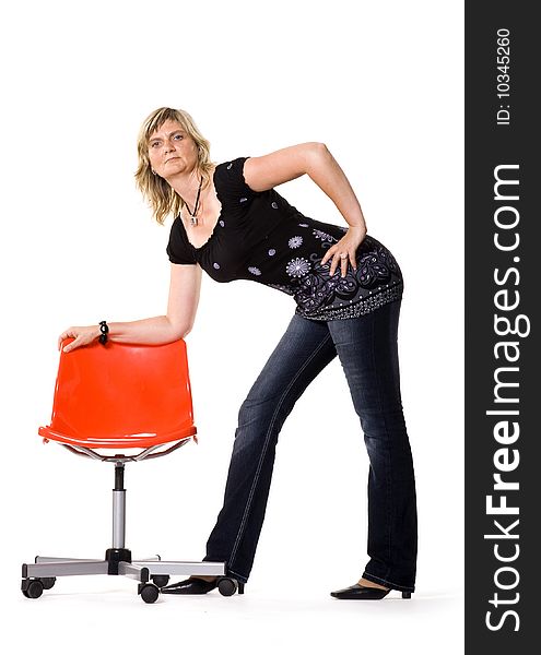 Beautiful middle aged woman posing with red chair