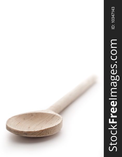 Vertical shallow focus close up of a wooden spoon