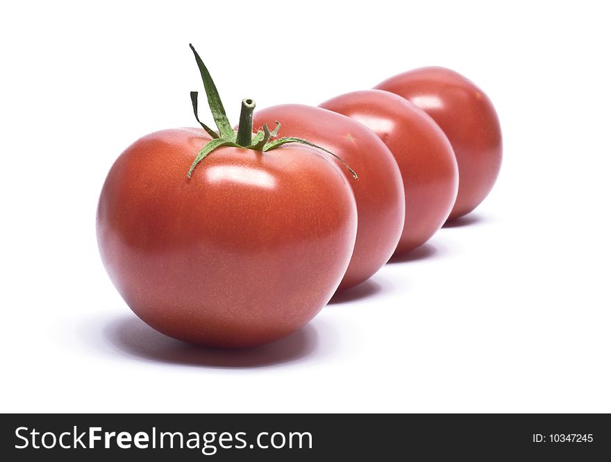 Four tomatoes which are presented on a white background