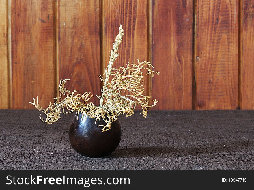 Small ikebana on brown table