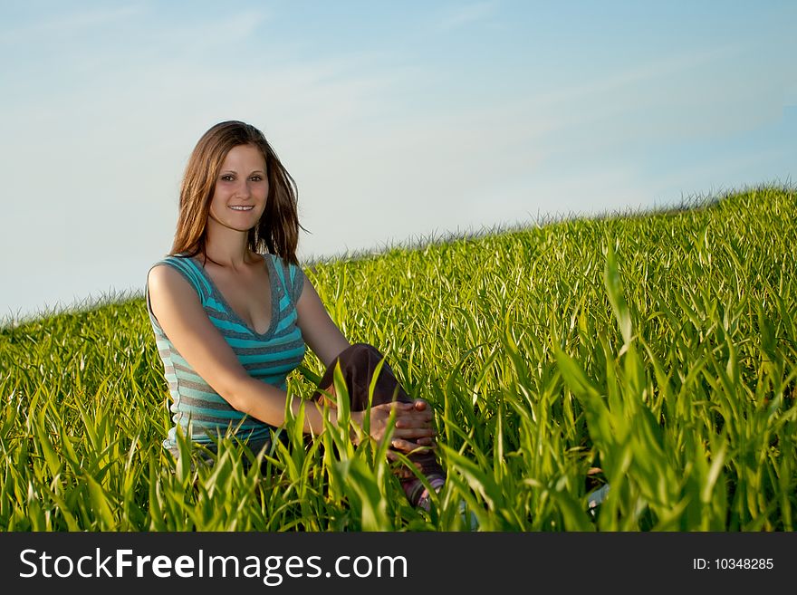Smiling woman sitting on grass