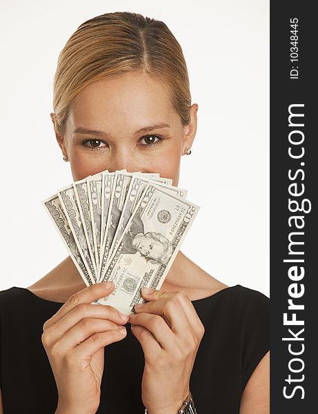 Businesswoman holding up hundreds and twenty dollars in front of her face. Businesswoman holding up hundreds and twenty dollars in front of her face