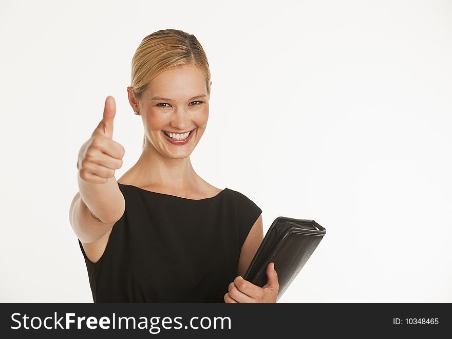 Businesswoman giving thumbs up to camera with white seamless background