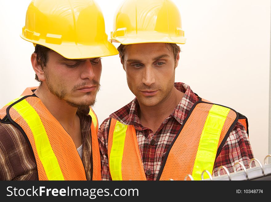 Two Construction Workers at the job working together