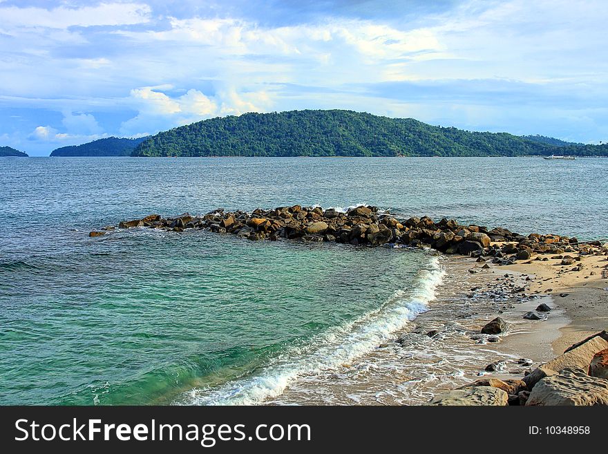 View of the beach on cloudy sunny day.