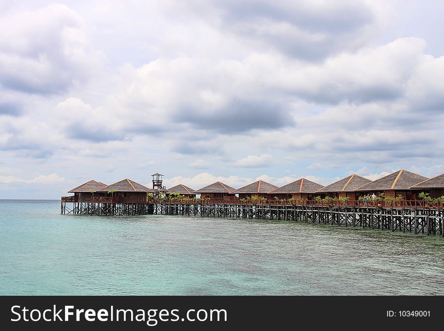 View of Sipdan water village resort at Mabul Island under cloudy day.