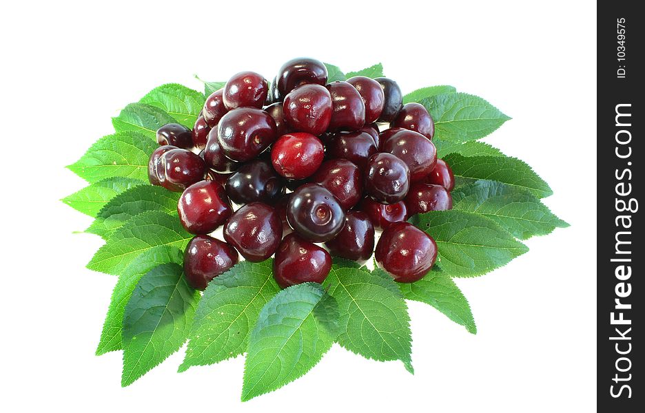 Red sweet cherry on leaves on a white background, it is isolated.