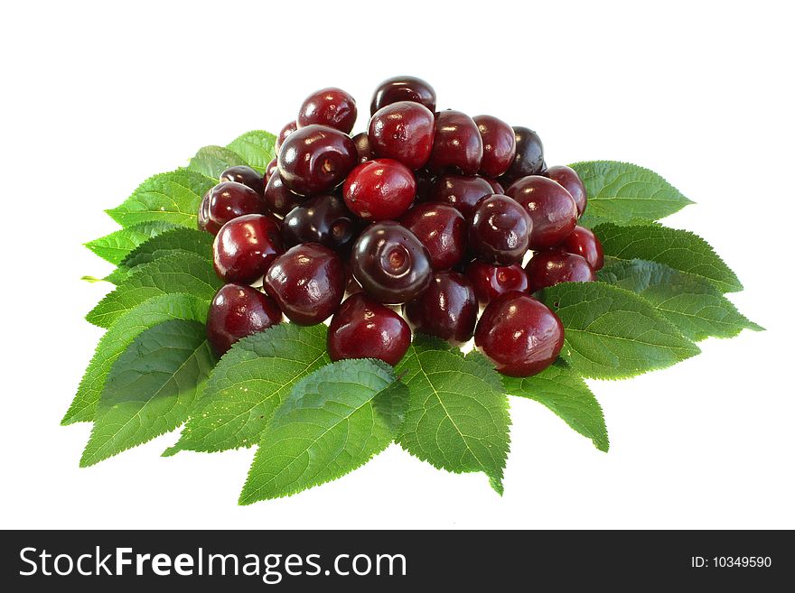 Red sweet cherry on leaves on a white background, it is isolated.