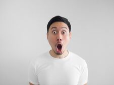 Shocked Face Of Man In White Shirt On Grey Background. Royalty Free Stock Photos