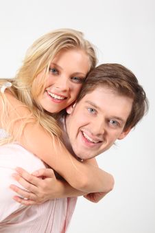 Girl Embraces Young Man For Neck Behind Royalty Free Stock Photo