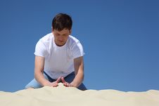 Guy Plays In Sand Against Blue Sky Stock Image Guy Plays In Sand Against Blue Sky Stock Image