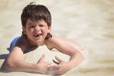 Boy Without Foreteeth Lies On Sand Stock Photos Boy Without Foreteeth Lies On Sand Stock Photos