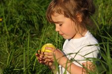 Girl In Grass With Green Apple Stock Photos