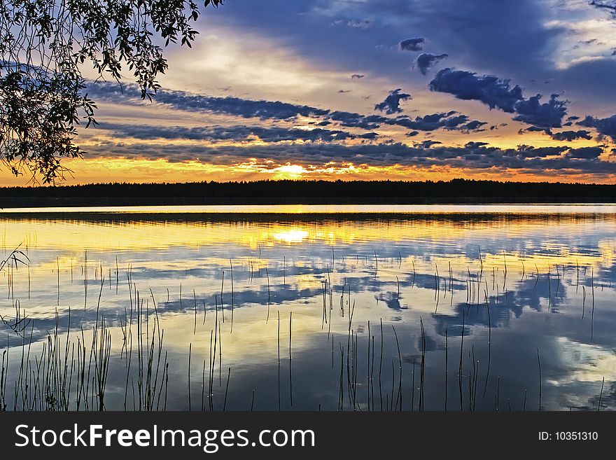 Still water, burning sunset and polar day. Still water, burning sunset and polar day